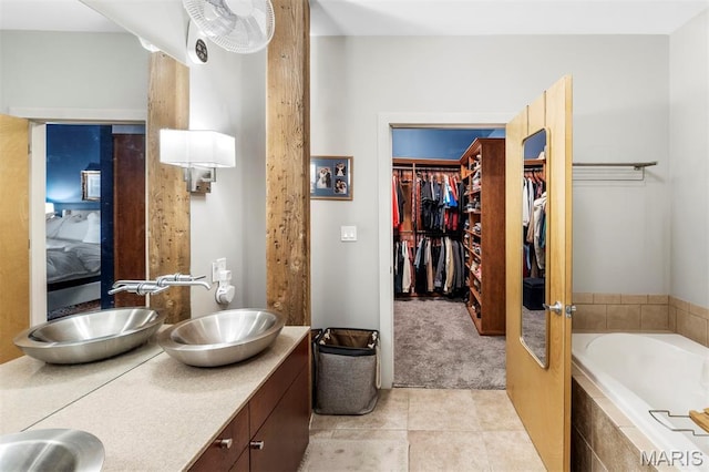 901 Washington Ave Unit 702, Saint Louis, MO 63101 - full bath with double vanity, tile patterned flooring, a bath, and a walk in closet