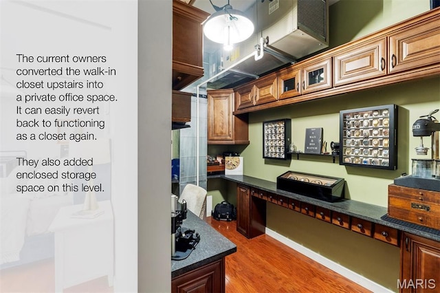 901 Washington Ave Unit 702, Saint Louis, MO 63101 - kitchen featuring wood finished floors and glass insert cabinets
