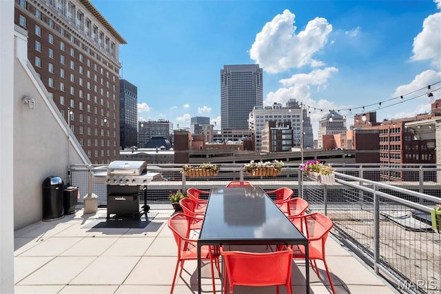 901 Washington Ave Unit 702, Saint Louis, MO 63101 - view of patio / terrace featuring area for grilling, a view of city, a balcony, and outdoor dining area