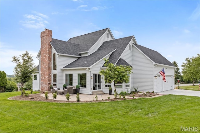 776 Hillenkamp Dr, Weldon Spring, MO 63304 - back of house featuring roof with shingles, concrete driveway, a chimney, a lawn, and an attached garage