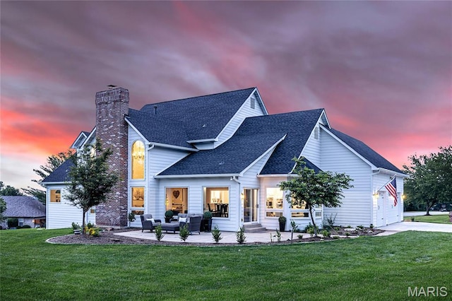 776 Hillenkamp Dr, Weldon Spring, MO 63304 - back of house at dusk with an outdoor living space, roof with shingles, a chimney, a lawn, and concrete driveway