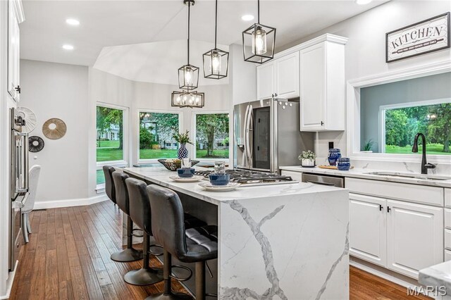776 Hillenkamp Dr, Weldon Spring, MO 63304 - kitchen featuring stainless steel appliances, white cabinets, a center island, light stone countertops, and recessed lighting