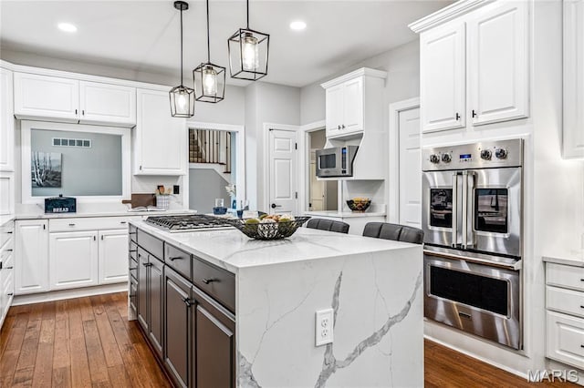 776 Hillenkamp Dr, Weldon Spring, MO 63304 - kitchen with appliances with stainless steel finishes, a center island, white cabinets, dark wood finished floors, and gray cabinetry