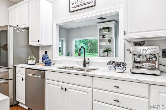 776 Hillenkamp Dr, Weldon Spring, MO 63304 - kitchen featuring appliances with stainless steel finishes, white cabinets, and light stone countertops