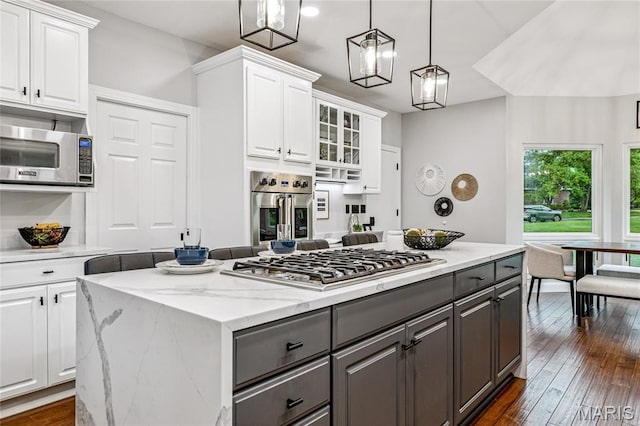 776 Hillenkamp Dr, Weldon Spring, MO 63304 - kitchen with gray cabinetry, appliances with stainless steel finishes, a center island, and white cabinets