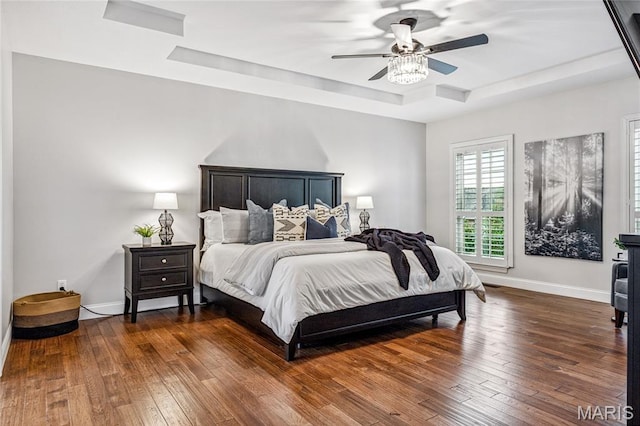 776 Hillenkamp Dr, Weldon Spring, MO 63304 - bedroom with a tray ceiling, dark wood-style flooring, and a ceiling fan