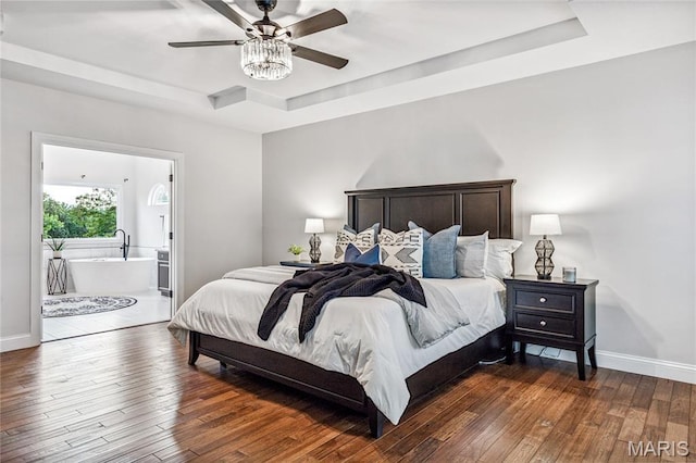 776 Hillenkamp Dr, Weldon Spring, MO 63304 - bedroom featuring a tray ceiling, hardwood / wood-style floors, connected bathroom, and a ceiling fan