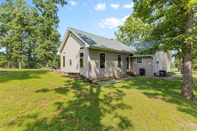 2004 Possum Hollow Rd, Farmington, MO 63640 - view of front facade with a front yard, entry steps, roof with shingles, and central AC unit