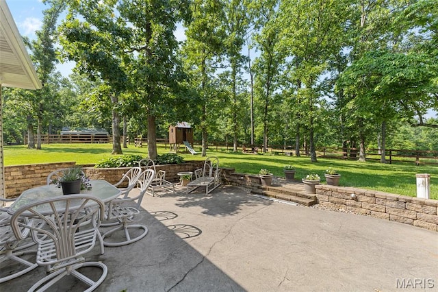2004 Possum Hollow Rd, Farmington, MO 63640 - view of patio featuring view of scattered trees, a playground, and outdoor dining area