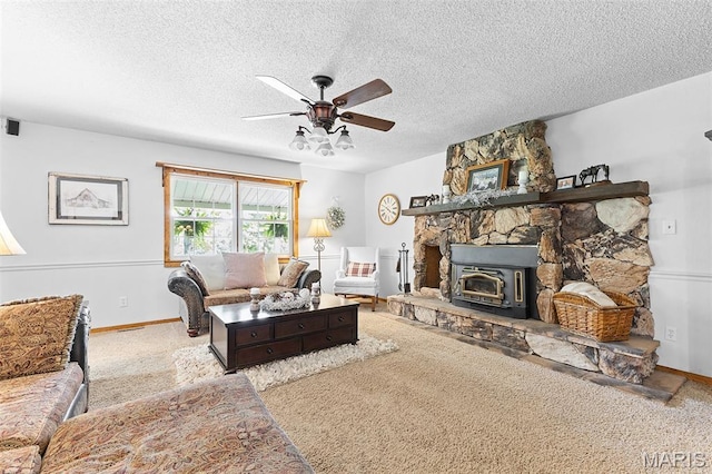 2004 Possum Hollow Rd, Farmington, MO 63640 - carpeted living area featuring a ceiling fan, a textured ceiling, a wood stove, and baseboards