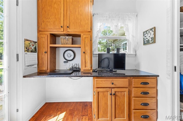 2004 Possum Hollow Rd, Farmington, MO 63640 - kitchen featuring dark wood-style flooring, open shelves, an office area, brown cabinetry, and dark stone countertops