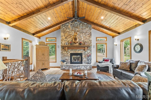 2004 Possum Hollow Rd, Farmington, MO 63640 - living area featuring a ceiling fan, wood ceiling, wood finished floors, a stone fireplace, and baseboards