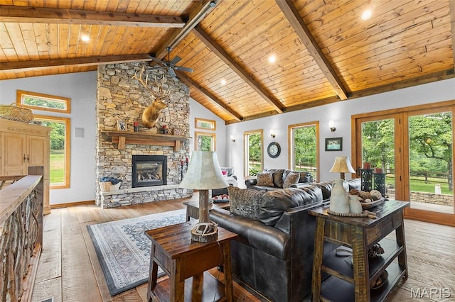 2004 Possum Hollow Rd, Farmington, MO 63640 - living room with wood ceiling with exposed beams, light wood-type flooring, a stone fireplace, baseboards, and a ceiling fan
