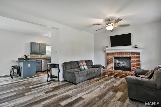 505 Lias Way, Wentzville, MO 63385 - living room with a ceiling fan, dark wood-style flooring, and a brick fireplace