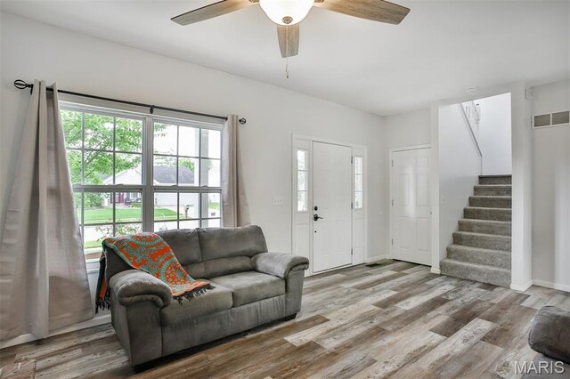 505 Lias Way, Wentzville, MO 63385 - living area featuring stairs, healthy amount of natural light, ceiling fan, and wood finished floors