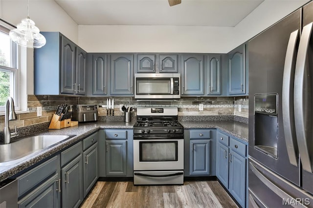 505 Lias Way, Wentzville, MO 63385 - kitchen with appliances with stainless steel finishes, dark countertops, dark wood-style floors, backsplash, and gray cabinetry