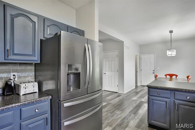505 Lias Way, Wentzville, MO 63385 - kitchen featuring stainless steel fridge with ice dispenser, blue cabinetry, dark countertops, and tasteful backsplash
