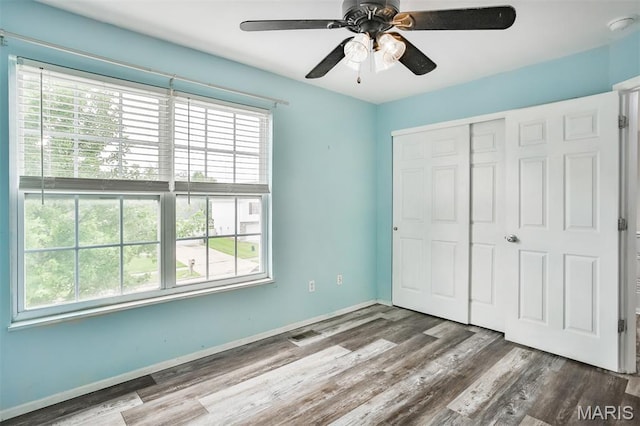 505 Lias Way, Wentzville, MO 63385 - unfurnished bedroom with a closet, wood finished floors, and ceiling fan