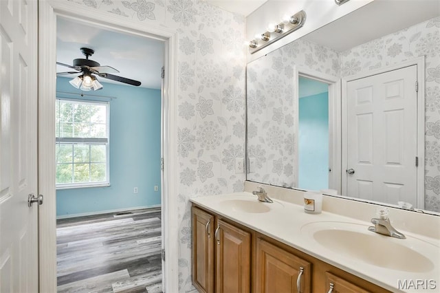 505 Lias Way, Wentzville, MO 63385 - full bathroom featuring double vanity, wood finished floors, ceiling fan, and wallpapered walls
