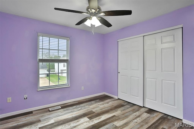 505 Lias Way, Wentzville, MO 63385 - unfurnished bedroom featuring wood finished floors, a ceiling fan, and a closet