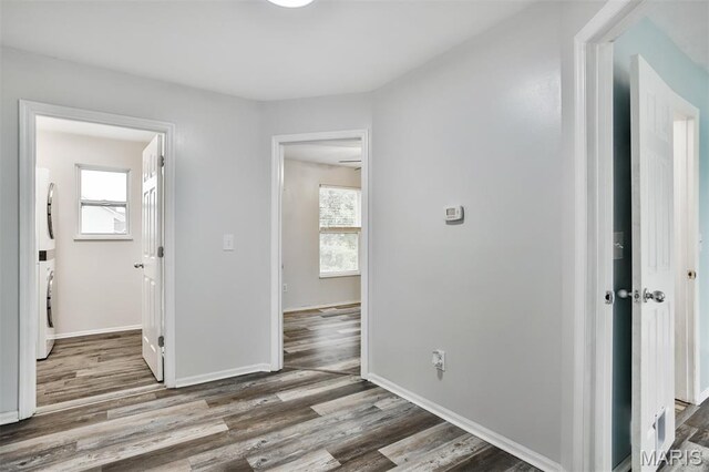 505 Lias Way, Wentzville, MO 63385 - hallway featuring stacked washer / drying machine and wood finished floors