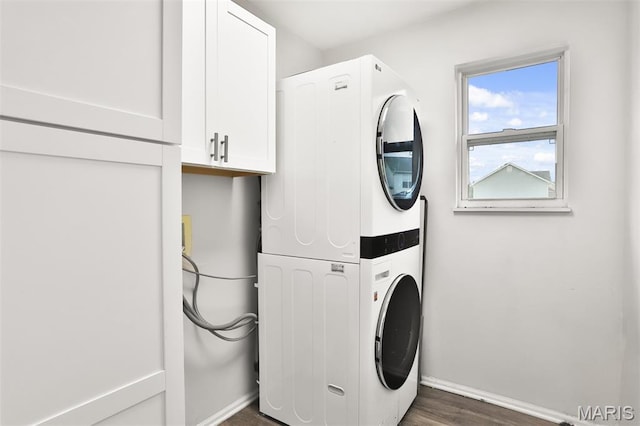 505 Lias Way, Wentzville, MO 63385 - laundry room featuring stacked washing machine and dryer, cabinet space, and dark wood-style floors