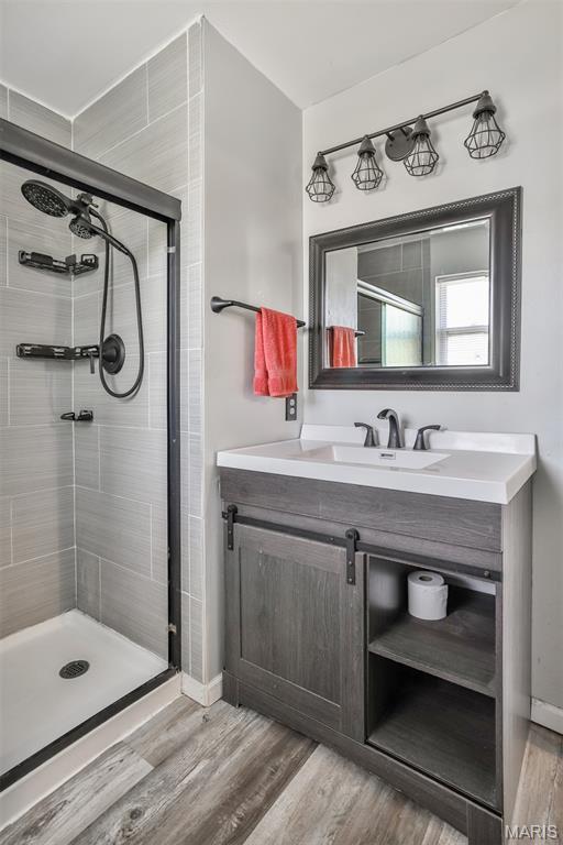 505 Lias Way, Wentzville, MO 63385 - full bath featuring a stall shower, vanity, and wood finished floors