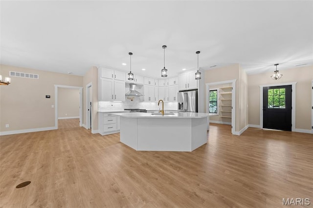 63 Plackemeier Dr, Ofallon, MO 63366 - kitchen featuring stainless steel refrigerator with ice dispenser, exhaust hood, a chandelier, a sink, and recessed lighting