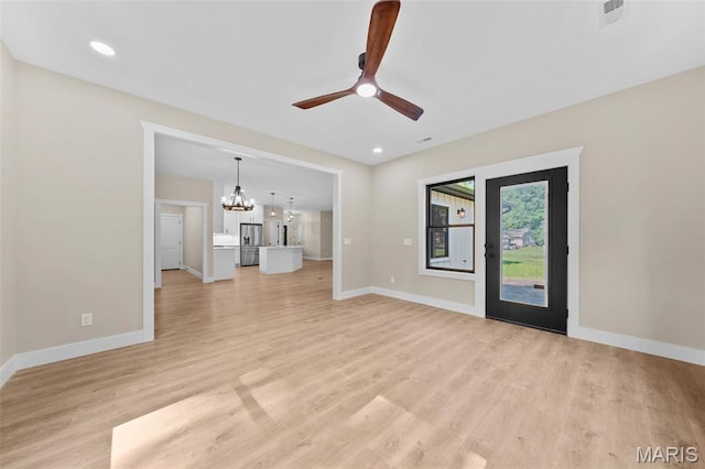 63 Plackemeier Dr, Ofallon, MO 63366 - unfurnished living room featuring a chandelier, ceiling fan, light wood-style flooring, baseboards, and recessed lighting