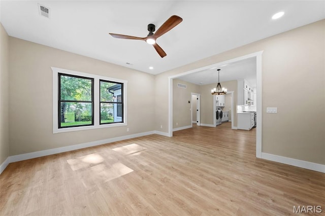 63 Plackemeier Dr, Ofallon, MO 63366 - unfurnished room featuring a ceiling fan, a chandelier, baseboards, light wood-style flooring, and recessed lighting