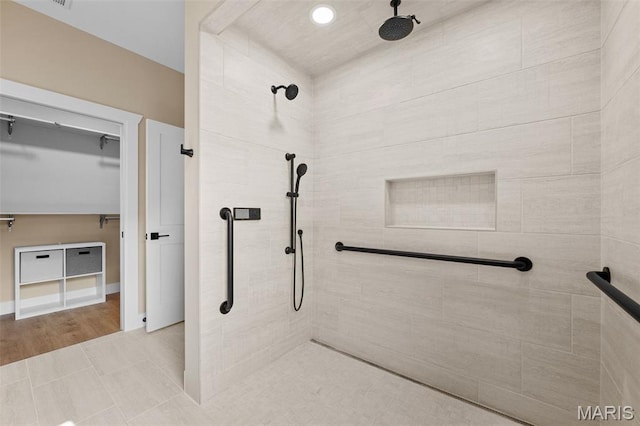 63 Plackemeier Dr, Ofallon, MO 63366 - full bathroom featuring a tile shower, a walk in closet, and recessed lighting
