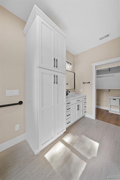 63 Plackemeier Dr, Ofallon, MO 63366 - bathroom with vanity, baseboards, and a closet