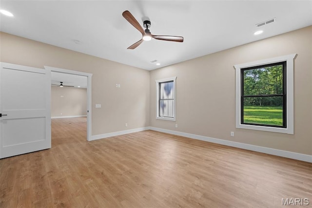 63 Plackemeier Dr, Ofallon, MO 63366 - spare room featuring ceiling fan, healthy amount of natural light, baseboards, light wood-type flooring, and recessed lighting