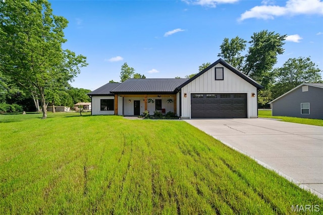 63 Plackemeier Dr, Ofallon, MO 63366 - modern farmhouse featuring board and batten siding, an attached garage, driveway, a front yard, and metal roof