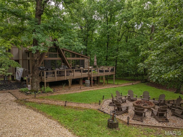 483 Hummingbird View Dr, Innsbrook, MO 63390 - view of green lawn with a fire pit and a wooden deck