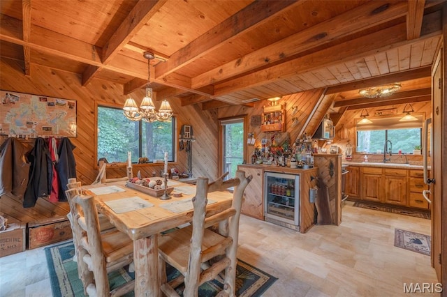 483 Hummingbird View Dr, Innsbrook, MO 63390 - dining area with wine cooler, wooden walls, a wooden ceiling with exposed beams, plenty of natural light, and a chandelier