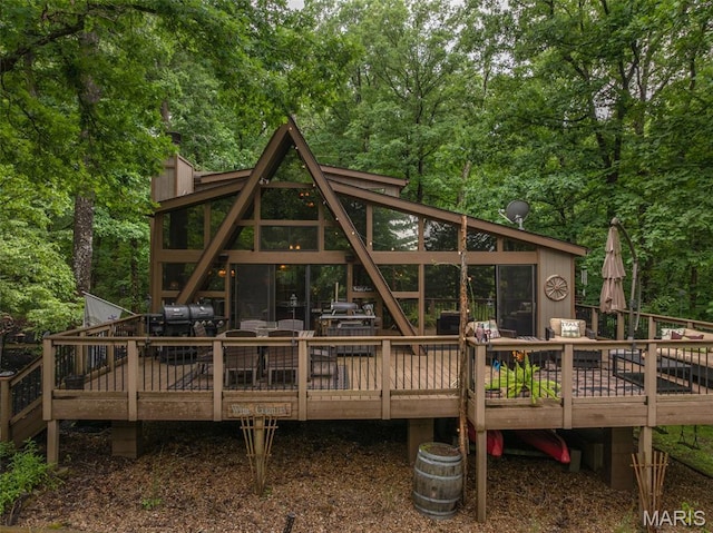 483 Hummingbird View Dr, Innsbrook, MO 63390 - rear view of house featuring a deck and a forest view