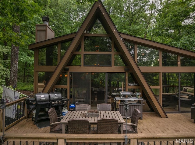 483 Hummingbird View Dr, Innsbrook, MO 63390 - wooden deck featuring outdoor dining space, grilling area, and view of scattered trees