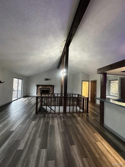 63 Spanish Wells Ct, Osage Beach, MO 65065 - living room with a textured ceiling, dark wood finished floors, and a fireplace