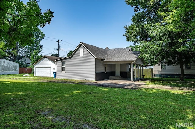 2428 E 25th St, Granite City, IL 62040 - rear view of house with a yard, a garage, roof with shingles, and a chimney