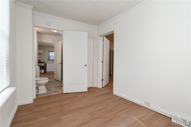 2428 E 25th St, Granite City, IL 62040 - unfurnished bedroom featuring ornamental molding, light wood-style floors, ensuite bathroom, and baseboards