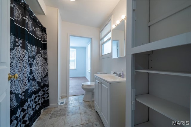 2428 E 25th St, Granite City, IL 62040 - full bathroom featuring toilet, vanity, baseboards, and healthy amount of natural light