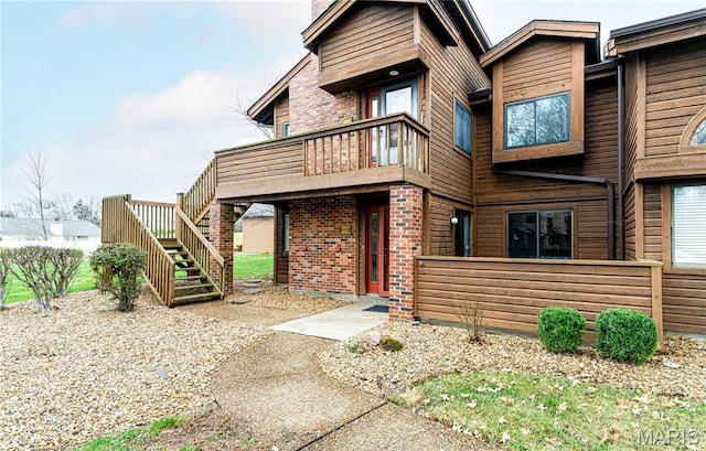 408 Kipling Way Unit A, Weldon Spring, MO 63304 - view of front of house featuring stairway, brick siding, and a chimney