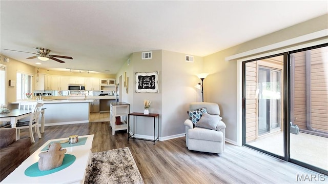 408 Kipling Way Unit A, Weldon Spring, MO 63304 - living room with wood finished floors, a ceiling fan, and rail lighting