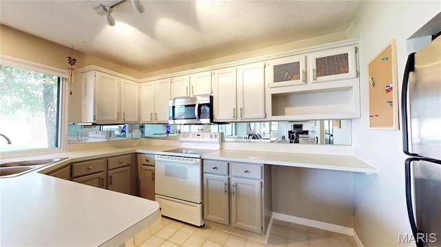 408 Kipling Way Unit A, Weldon Spring, MO 63304 - kitchen featuring appliances with stainless steel finishes, gray cabinetry, track lighting, light countertops, and a textured ceiling