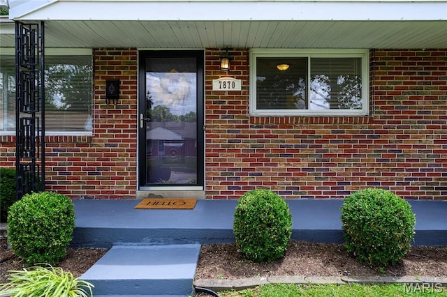 7870 Trenton Ave, University City, MO 63130 - doorway to property with covered porch and brick siding
