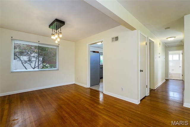 7870 Trenton Ave, University City, MO 63130 - unfurnished room featuring healthy amount of natural light, wood finished floors, a chandelier, and a smoke detector