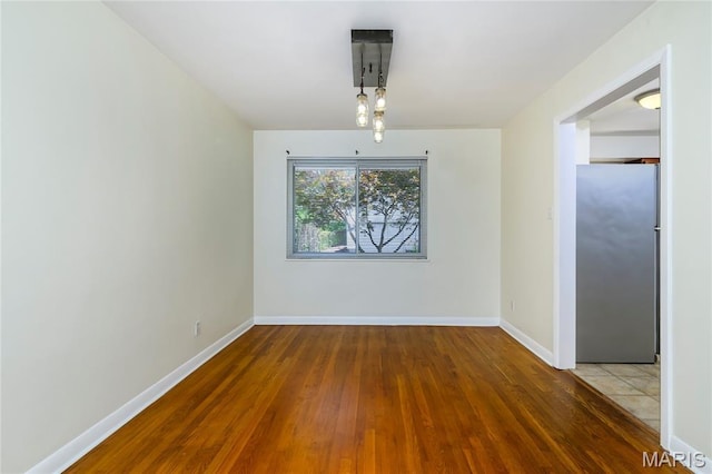 7870 Trenton Ave, University City, MO 63130 - unfurnished dining area with wood finished floors and baseboards