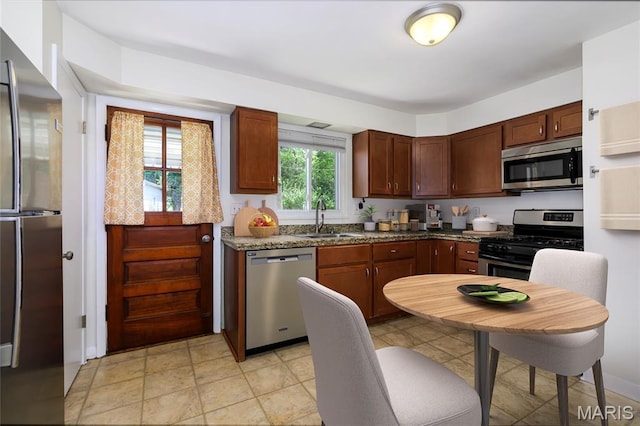 7870 Trenton Ave, University City, MO 63130 - kitchen featuring appliances with stainless steel finishes and dark stone counters