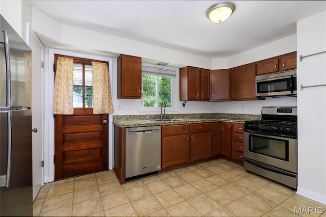 7870 Trenton Ave, University City, MO 63130 - kitchen featuring stainless steel appliances and dark stone counters